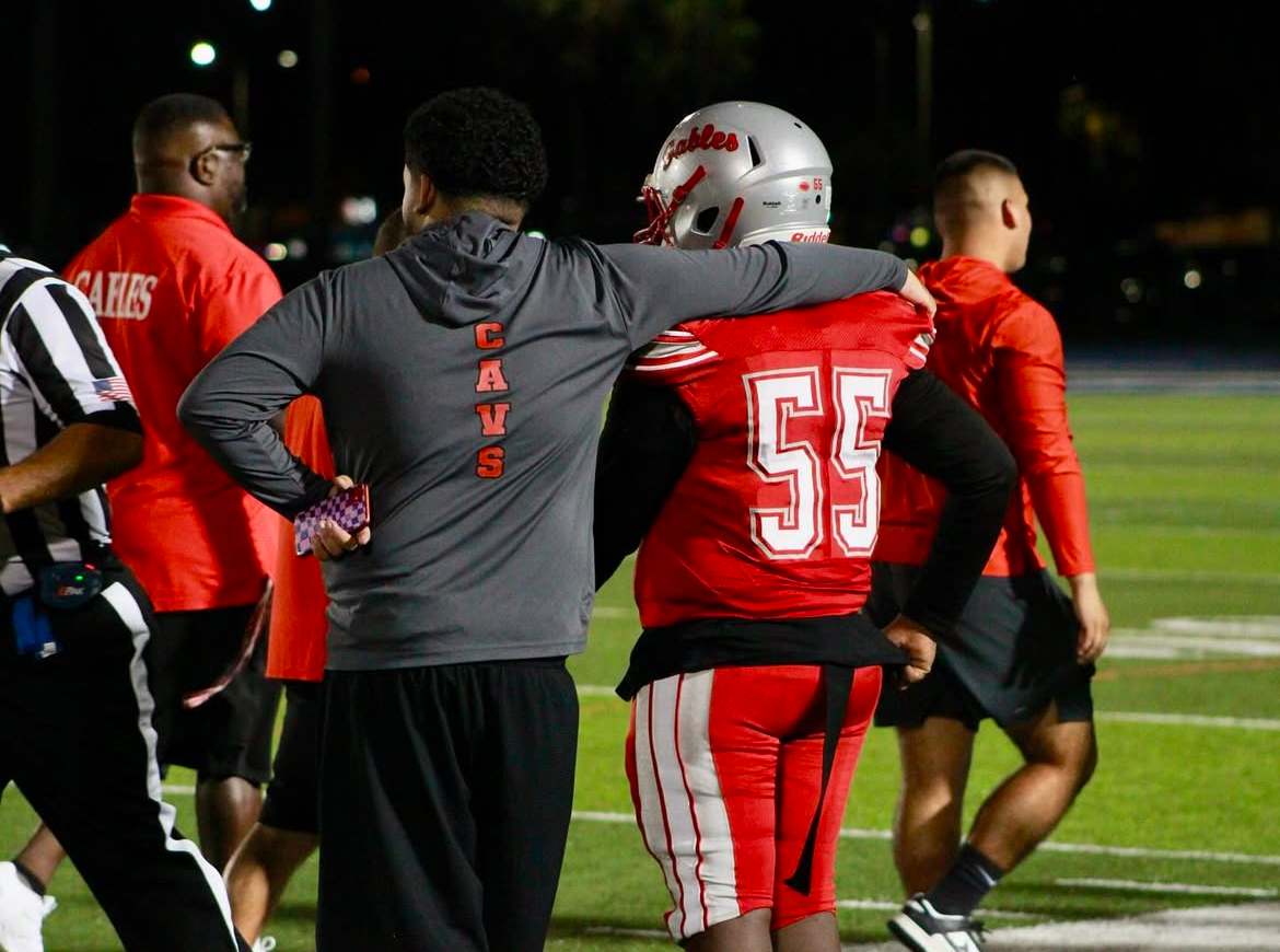 Preparing on the sidelines, the Cavaliers special team coach runs the route with his dependable players.